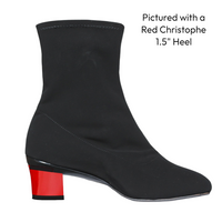 Black ankle boot with a red heel on a white background