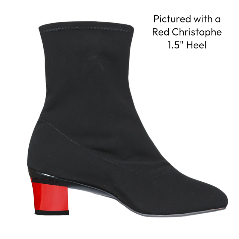 Black ankle boot with a red heel on a white background