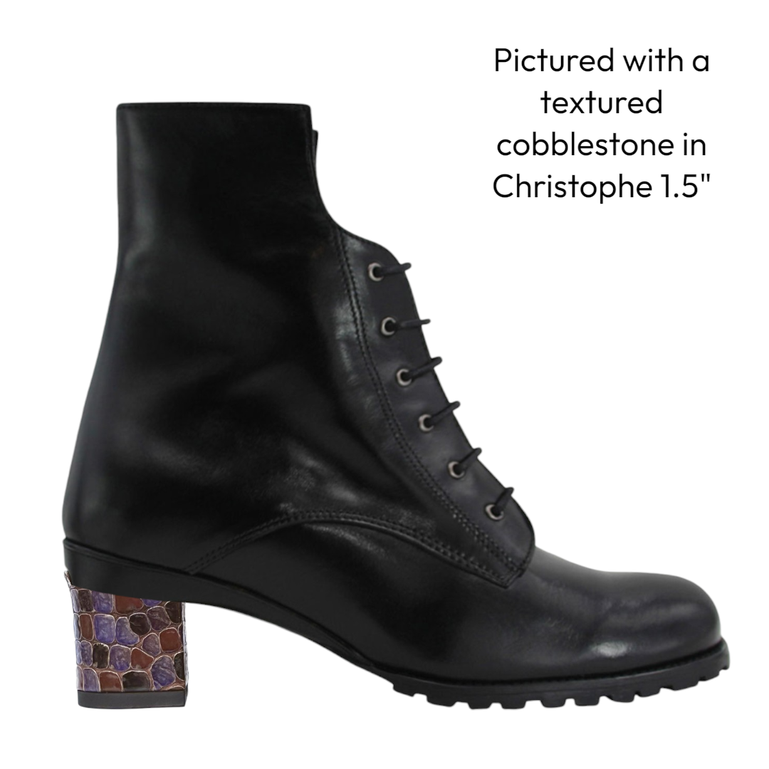 Black combat leather boot with textured low heel on a white background