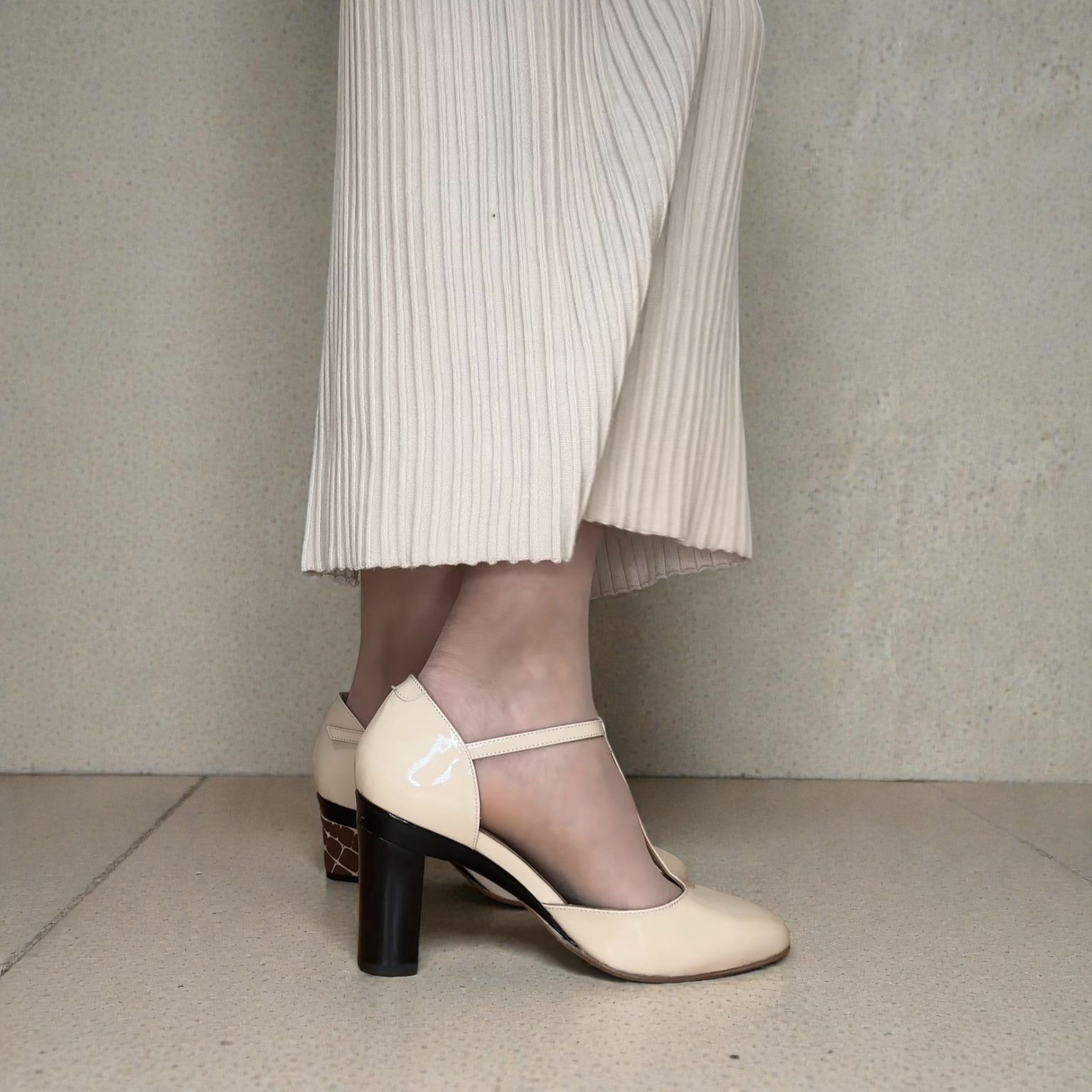 tanya heath us t-strap pump in nude patent with high block heel.