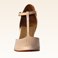Beige high-heeled shoe with a T-strap on a white background