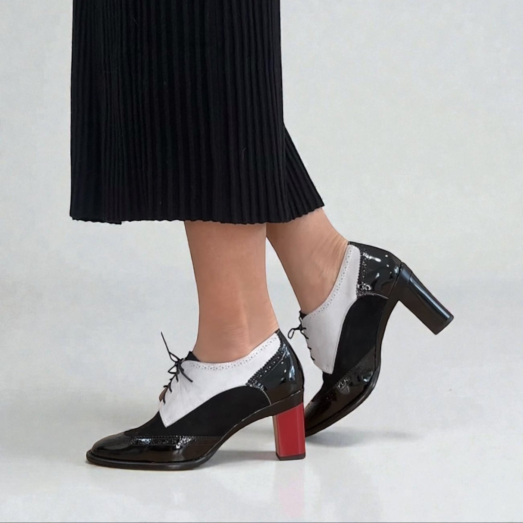 Black and white oxford shoes. one with red 2.5" heel and one with black 3.3" block heel. tanya heath us
