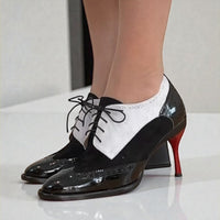 Black and white patent leather oxford shoes with red soles worn by Sally at TANYA HEATH US